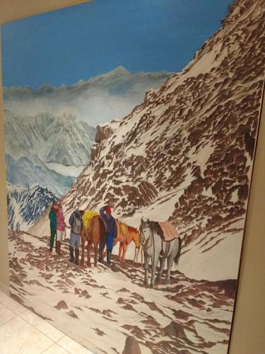 a painting of people with horses on a snowy mountain at Posada Cavieres Wine Farm in Maipú