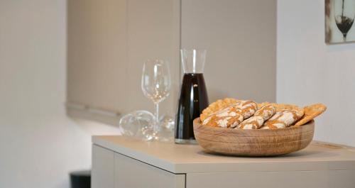 a bowl of bread and a bottle of wine at Innerluferhof in Rifiano