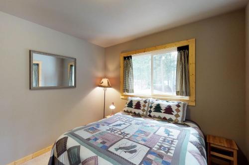 a bedroom with a bed and a window at Peaceful Pines in Plain