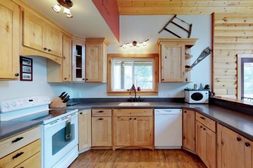 a kitchen with wooden cabinets and a sink at Peaceful Pines in Plain