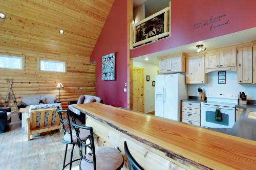 a kitchen with a bar and a living room at Peaceful Pines in Plain