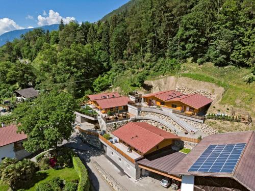 an aerial view of a building with a solar array at Innerluferhof in Rifiano