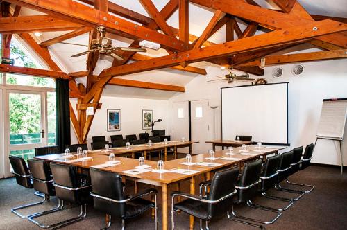 a large conference room with a long table and chairs at Logis Hôtel Restaurant Du Lion D'argent Et Des Tanneries in La Châtre