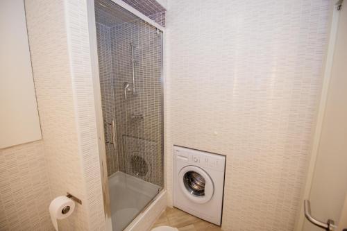 a bathroom with a washing machine in a shower at Apartment 63 - 1 in Zagreb