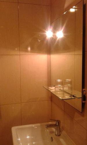 a bathroom with a sink and a mirror at Hotel Tic Tac in Bragança