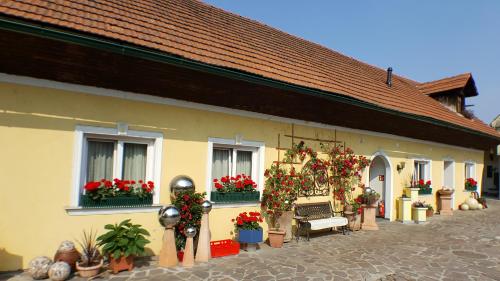 a building with potted plants on the side of it at Pension Arkadenhof in Premstätten