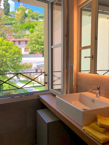 a bathroom with a sink and a window at Castelli Delux in Menaggio
