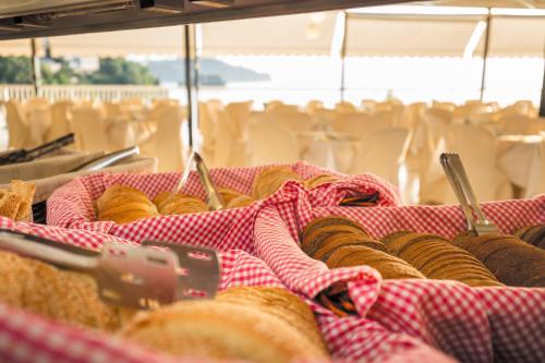 a bunch of donuts are being made on a table at Oasis Hotel in Perama