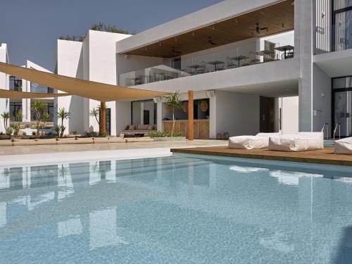 a swimming pool in front of a house at Cavo Vezal in Laganas