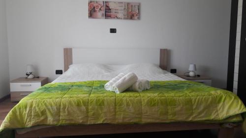 a bedroom with a bed with two towels on it at App. Adriatic Aurora in Umag