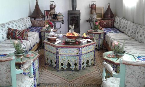 a living room with two couches and a table at Villa Pomme d'Or in Midelt