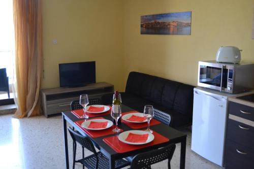a living room with a table with two wine glasses at Le Malte House St. Julians in St Julian's