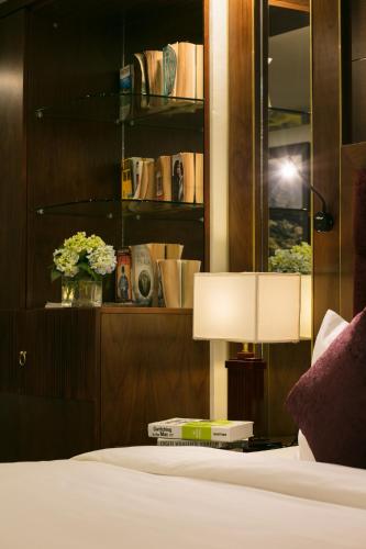 a bedroom with a bed and a table with a lamp at Sapa Horizon Hotel in Sa Pa