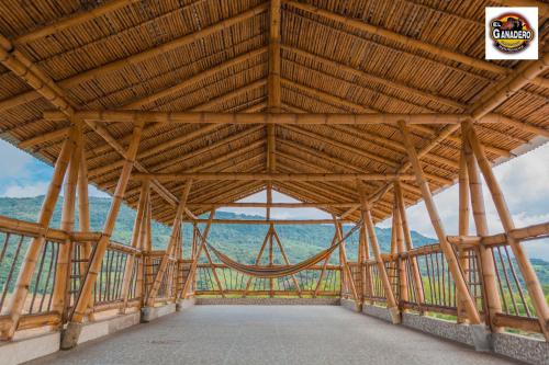 a large timber frame building with a large wooden ceiling at Hotel El Ganadero in El Total
