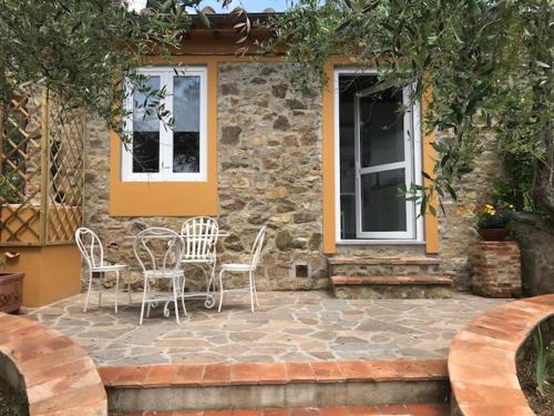 a patio with chairs and a table in front of a building at Il Casalone in Impruneta