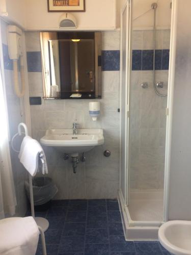 a bathroom with a sink and a shower at Hotel Perla Del Mare in Lido di Camaiore