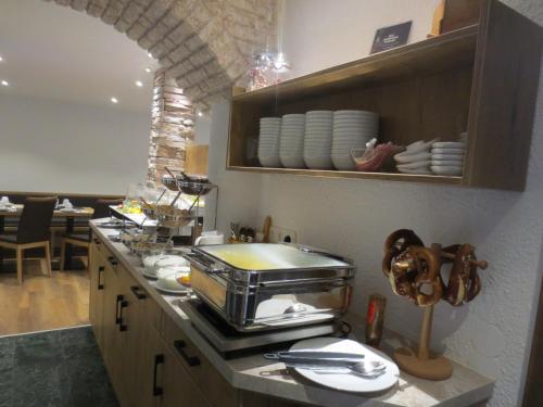 a kitchen with a counter with a toaster at Hotel Alp Inn - Chiemgaukarte inclusive in Ruhpolding