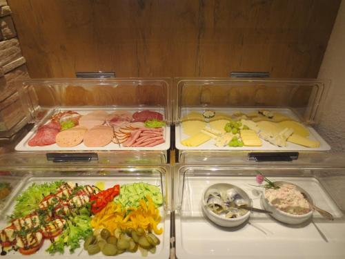 two plastic containers filled with different types of food at Hotel Alp Inn - Chiemgaukarte inclusive in Ruhpolding