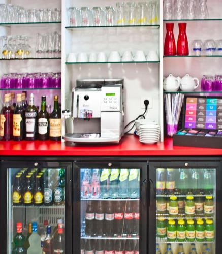 a refrigerator filled with lots of bottles and drinks at The Originals City, Hôtel des Lys, Dreux in Dreux