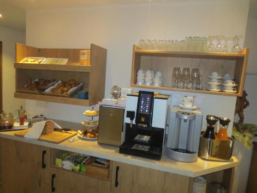 a kitchen with a coffee maker on a counter at Hotel Alp Inn - Chiemgaukarte inclusive in Ruhpolding