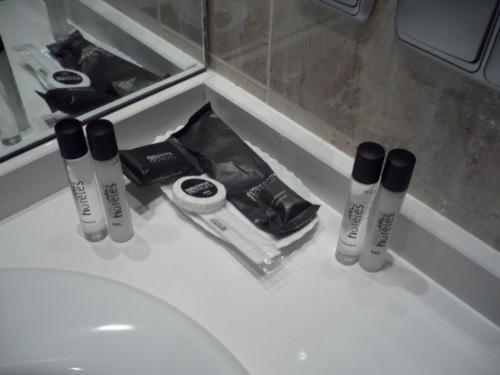 a bathroom sink with a bunch of products on it at Valcarce Urbasa in Olazagutía