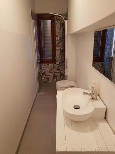 a white bathroom with a toilet and a sink at Allegra Toscana - Affittacamere Guest house Arezzo in Arezzo