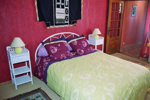 a bedroom with a bed and two night stands at le four au bois in Futeau