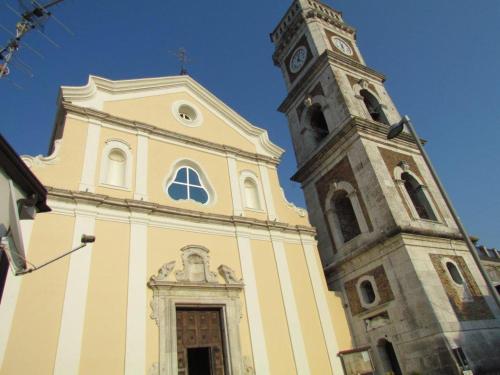 a church with a clock tower on top of it at B&B Da Luca in Grottaminarda