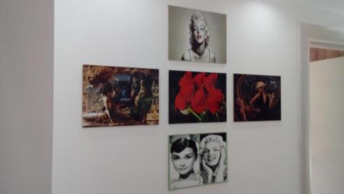 a bunch of pictures hanging on a wall at Apartman Rustik in Belgrade