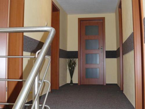 a room with a doorway and a door with a plant at Penzion Chalupka Vysoke Tatry štrba in Vysoké Tatry