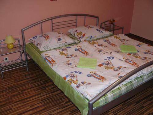A bed or beds in a room at Penzion Chalupka