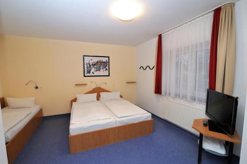 Säng eller sängar i ett rum på Sporthotel Borussia Düsseldorf