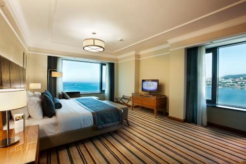 a hotel room with a bed and large windows at Dedeman Zonguldak in Zonguldak