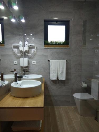 a bathroom with a sink and a toilet at Vistadouro 3 Style in Peso da Régua