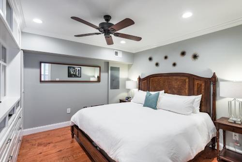 a bedroom with a bed and a ceiling fan at The Quarters on Vendue in Charleston