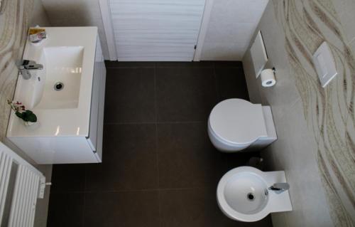 a bathroom with a white toilet and a sink at Spuma di mare in Gallipoli