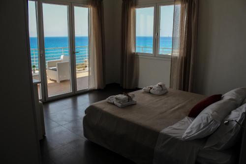 a bedroom with a bed and a view of the ocean at Spuma di mare in Gallipoli