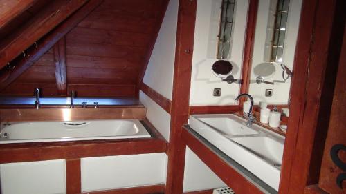a bathroom with a tub and a sink at 14 Century Water Mill in Mořina