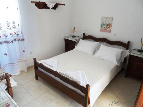 ein Schlafzimmer mit einem großen Bett mit weißer Bettwäsche in der Unterkunft Liolio's Manor in Agalianós