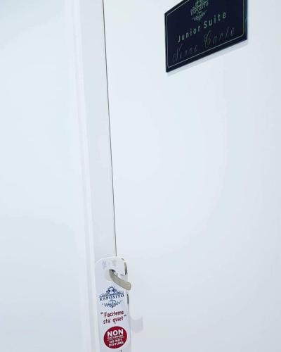 a refrigerator door with a sign on it at ESPOSITO PLAZA- ROOMS & SUITE in Naples