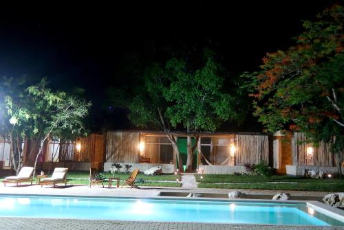 a house with a swimming pool at night at Hotel Casa de Campo Conkal Merida in Conkal
