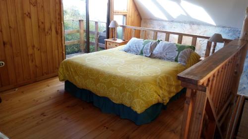 a bedroom with a bed with a wooden floor at Algarrobo Suites in Algarrobo