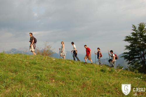 a group of people walking up a hill at Villa Gjeçaj Guesthouse and Restaurant in Theth