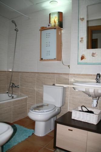a bathroom with a toilet and a sink at You & Me in Jávea
