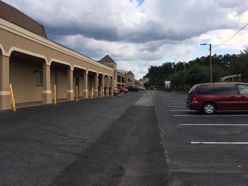 a car parked in a parking lot next to a building at Super 8 by Wyndham Augusta in Augusta