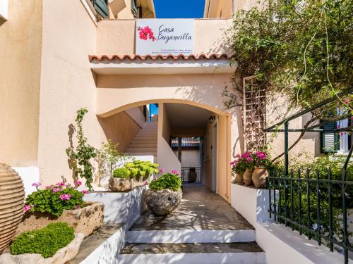 a building with stairs and potted plants at Casa Buganvilla in Minia