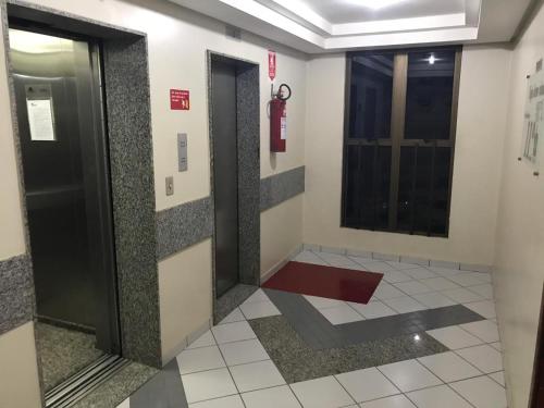 a hallway with two elevators in a building at Oft Plaza Oeste Hotel in Goiânia