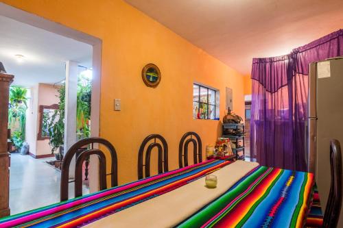 a dining room with a table with a colorful table cloth at Casa De Leon in Antigua Guatemala