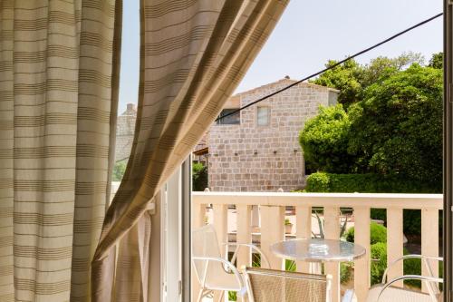 a view from a balcony with a table and chairs at Apartments Viva in Korčula