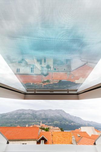 a view from a window of a town with red roofs at Apartments Viva in Korčula